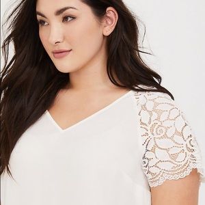 Torrid Off-white blouse with lace sleeves.